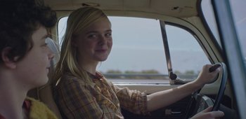 Movie still from “20th Century Women” (2016), directed by Mike Mills – A woman sitting in the driver's seat of a car; Close Up shot, Over the shoulder angle