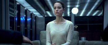 Movie still from “3 Days to Kill” (2014), directed by McG – A woman sitting on a chair in front of a window; Medium shot, Over the shoulder angle