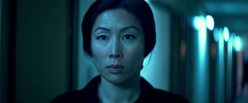 Movie still from “3 Days to Kill” (2014), directed by McG – A person wearing a black shirt; Close Up shot, Low angle