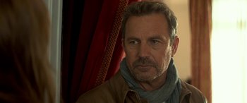 Movie still from “3 Days to Kill” (2014), directed by McG – A person wearing a scarf; Close Up shot, Over the shoulder angle