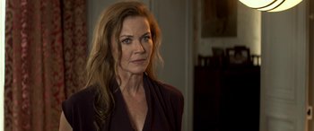 Movie still from “3 Days to Kill” (2014), directed by McG – A person with long brown hair; Close Up shot, Over the shoulder angle