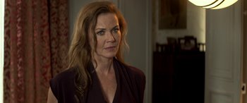 Movie still from “3 Days to Kill” (2014), directed by McG – A person with long brown hair; Close Up shot, Over the shoulder angle