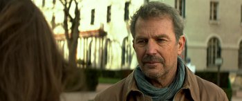 Movie still from “3 Days to Kill” (2014), directed by McG – A person wearing a jacket; Close Up shot, Over the shoulder angle