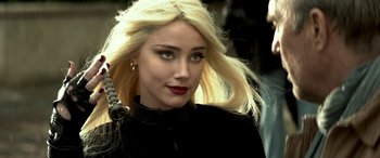 Movie still from “3 Days to Kill” (2014), directed by McG – A woman with blonde hair and red lipstick; Close Up shot, Over the shoulder angle