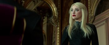 Movie still from “3 Days to Kill” (2014), directed by McG – A woman with long blonde hair wearing a black dress; Close Up shot, Over the shoulder angle