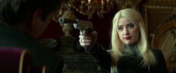 Movie still from “3 Days to Kill” (2014), directed by McG – A woman holding a gun in her hand; Close Up shot, Over the shoulder angle