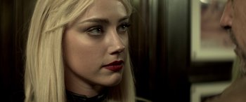 Movie still from “3 Days to Kill” (2014), directed by McG – A person with long blonde hair; Close Up shot, Over the shoulder angle
