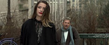 Movie still from “3 Days to Kill” (2014), directed by McG – A man and a woman are standing in front of each other; Medium shot, Over the shoulder angle