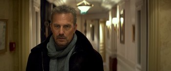 Movie still from “3 Days to Kill” (2014), directed by McG – A person wearing a coat and a scarf; Close Up shot, Low angle