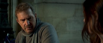 Movie still from “3 Days to Kill” (2014), directed by McG – A person wearing a gray sweater; Close Up shot, Low angle