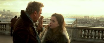 Movie still from “3 Days to Kill” (2014), directed by McG – A man and a woman are standing next to each other; Close Up shot, Over the shoulder angle