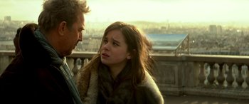 Movie still from “3 Days to Kill” (2014), directed by McG – A man and a woman standing next to each other; Close Up shot, Over the shoulder angle