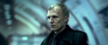 Movie still from “3 Days to Kill” (2014), directed by McG – A person wearing a black shirt; Close Up shot, Low angle