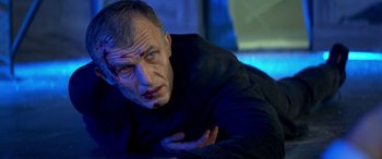 Movie still from “3 Days to Kill” (2014), directed by McG – A person wearing a black shirt; Close Up shot, Low angle