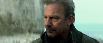 Movie still from “3 Days to Kill” (2014), directed by McG – An older man with grey hair looking down; Close Up shot, Low angle