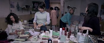 Movie still from “4 Months, 3 Weeks and 2 Days” (2007), directed by Cristian Mungiu – Two women are working on a project in a cluttered room; Medium shot, High angle