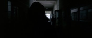 Movie still from “4 Months, 3 Weeks and 2 Days” (2007), directed by Cristian Mungiu – A person is standing in a dark room; Close Up shot, Low angle