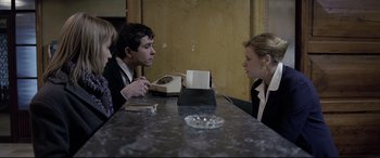 Movie still from “4 Months, 3 Weeks and 2 Days” (2007), directed by Cristian Mungiu – A man and a woman sitting at a table talking; Medium shot, Over the shoulder angle