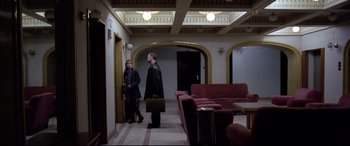 Movie still from “4 Months, 3 Weeks and 2 Days” (2007), directed by Cristian Mungiu – A man and a woman are standing in a room; Wide shot, High angle
