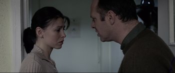 Movie still from “4 Months, 3 Weeks and 2 Days” (2007), directed by Cristian Mungiu – A man and a woman face to face in a room; Close Up shot, Over the shoulder angle