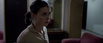 Movie still from “4 Months, 3 Weeks and 2 Days” (2007), directed by Cristian Mungiu – A woman sitting in front of a mirror in a room; Close Up shot, Low angle