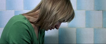 Movie still from “4 Months, 3 Weeks and 2 Days” (2007), directed by Cristian Mungiu – A person with long hair; Close Up shot, High angle