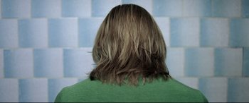 Movie still from “4 Months, 3 Weeks and 2 Days” (2007), directed by Cristian Mungiu – The back of a person's head with long brown hair; Close Up shot, High angle