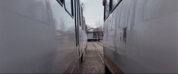Movie still from “4 Months, 3 Weeks and 2 Days” (2007), directed by Cristian Mungiu – Two trains are parked next to each other on the train tracks; Wide shot, High angle