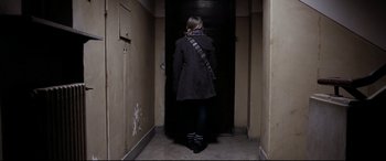 Movie still from “4 Months, 3 Weeks and 2 Days” (2007), directed by Cristian Mungiu – A woman is walking down the hall way; Wide shot, Low angle
