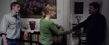 Movie still from “4 Months, 3 Weeks and 2 Days” (2007), directed by Cristian Mungiu – A woman in a green shirt is holding something; Medium shot, Over the shoulder angle