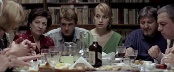 Movie still from “4 Months, 3 Weeks and 2 Days” (2007), directed by Cristian Mungiu – A man and a woman sitting at a dinner table; Medium shot, Over the shoulder angle