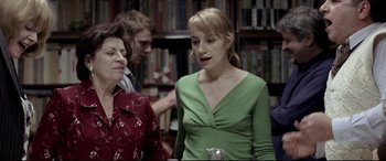 Movie still from “4 Months, 3 Weeks and 2 Days” (2007), directed by Cristian Mungiu – A woman standing next to another woman in a library; Medium shot, Over the shoulder angle