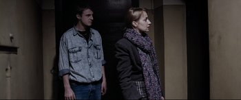 Movie still from “4 Months, 3 Weeks and 2 Days” (2007), directed by Cristian Mungiu – A man and a woman standing next to each other; Medium shot, Over the shoulder angle