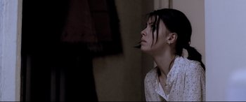 Movie still from “4 Months, 3 Weeks and 2 Days” (2007), directed by Cristian Mungiu – A young woman looking up into the air; Close Up shot, Low angle