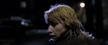 Movie still from “4 Months, 3 Weeks and 2 Days” (2007), directed by Cristian Mungiu – A woman with blonde hair is smoking a cigarette; Close Up shot, Low angle