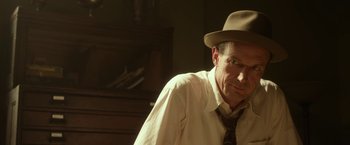 Movie still from “42” (2013), directed by Brian Helgeland – A man wearing a hat and a tie in a room; Close Up shot, Low angle
