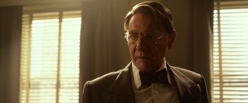Movie still from “42” (2013), directed by Brian Helgeland – An older man wearing a suit and bow tie; Close Up shot, Low angle