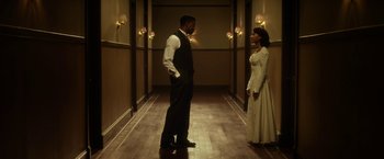 Movie still from “42” (2013), directed by Brian Helgeland – A man and a woman standing in a hallway; Wide shot, Low angle
