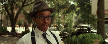 Movie still from “42” (2013), directed by Brian Helgeland – A man wearing a hat , glasses and a tie; Close Up shot, Over the shoulder angle