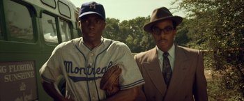 Movie still from “42” (2013), directed by Brian Helgeland – Two baseball players standing next to each other; Medium shot, Over the shoulder angle