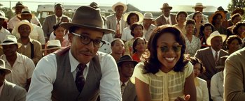 Movie still from “42” (2013), directed by Brian Helgeland – A group of people sitting in front of each other wearing hats; Medium shot, Over the shoulder angle