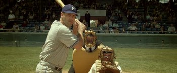 Movie still from “42” (2013), directed by Brian Helgeland – A baseball player holding a baseball bat next to a catcher and umpire; Medium shot, Over the shoulder angle