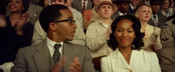 Movie still from “42” (2013), directed by Brian Helgeland – A group of people sitting in front of each other; Close Up shot, Over the shoulder angle