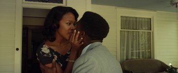 Movie still from “42” (2013), directed by Brian Helgeland – A man and a woman are kissing each other in front of a window; Close Up shot, Low angle