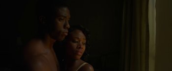 Movie still from “42” (2013), directed by Brian Helgeland – A man and a woman standing next to each other in the dark; Close Up shot, Low angle