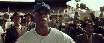 Movie still from “42” (2013), directed by Brian Helgeland – A baseball player in a crowd of people; Close Up shot, Low angle