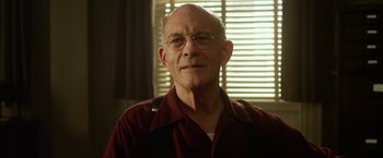 Movie still from “42” (2013), directed by Brian Helgeland – An older man wearing glasses and a red shirt; Close Up shot, Low angle