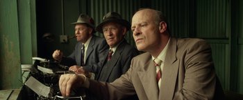 Movie still from “42” (2013), directed by Brian Helgeland – A group of men sitting next to each other in suits; Medium shot, Low angle
