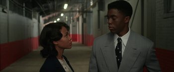 Movie still from “42” (2013), directed by Brian Helgeland – A man and a woman standing next to each other; Medium shot, Low angle