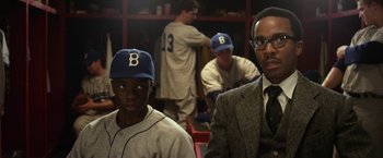 Movie still from “42” (2013), directed by Brian Helgeland – Two baseball players are sitting next to each other in a locker room; Medium shot, Over the shoulder angle